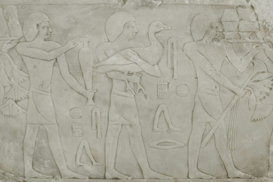 Assyrian palace reliefs winged figures ancient stone wall