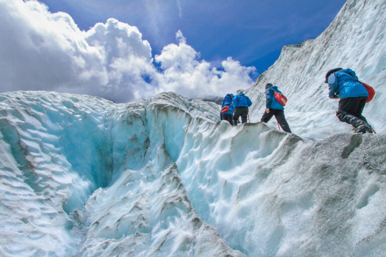 Archaeologists working glacier ice historical mountaineering gear ropes