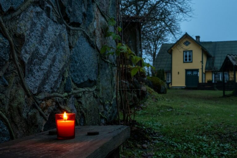 Medieval sundial stone wall hourglass candle flame darkness