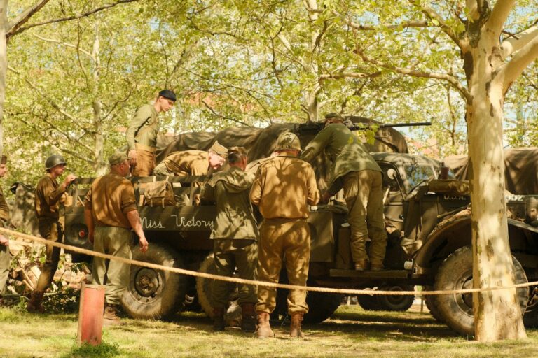 Soldiers setting inflatable tank vintage field loudspeakers truck
